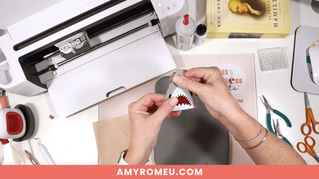 gluing while making a faux leather shark keychain with a Cricut