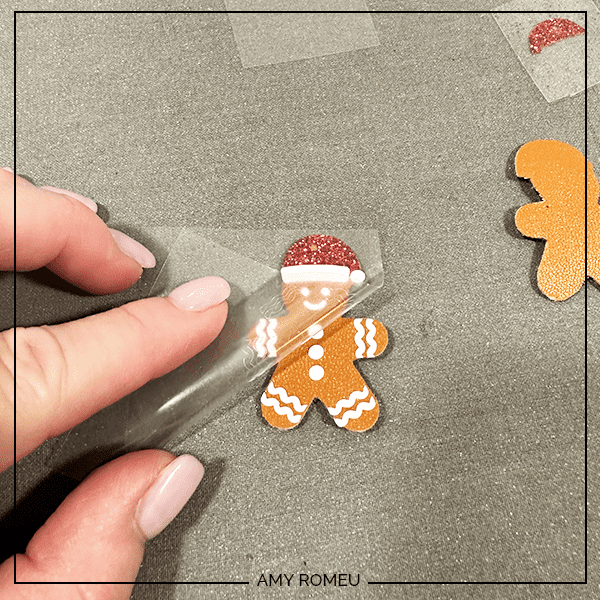 pressing white vinyl onto faux leather gingerbread man earrings