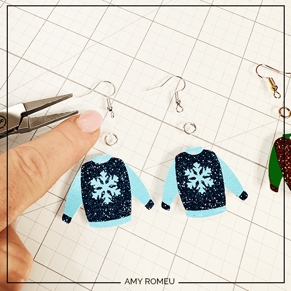 attaching earring hooks to peeling vinyl carrier sheChristmas Sweater earrings made with a Cricut