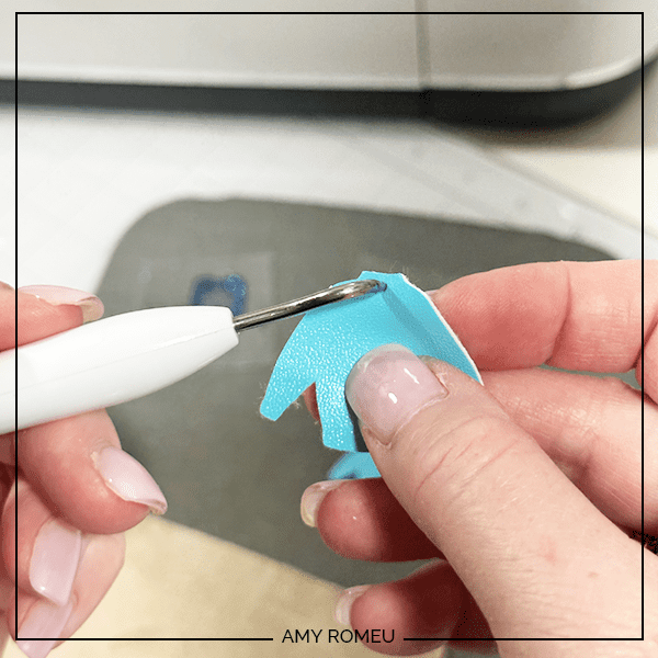 making faux leather earring hole with a sharp weeding tool