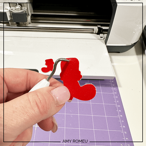finishing earring holes for Santa Boot Earrings made with a Cricut