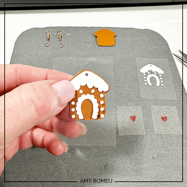 layering heat transfer vinyl for Faux Leather Gingerbread Cookie Earrings made with a Cricut