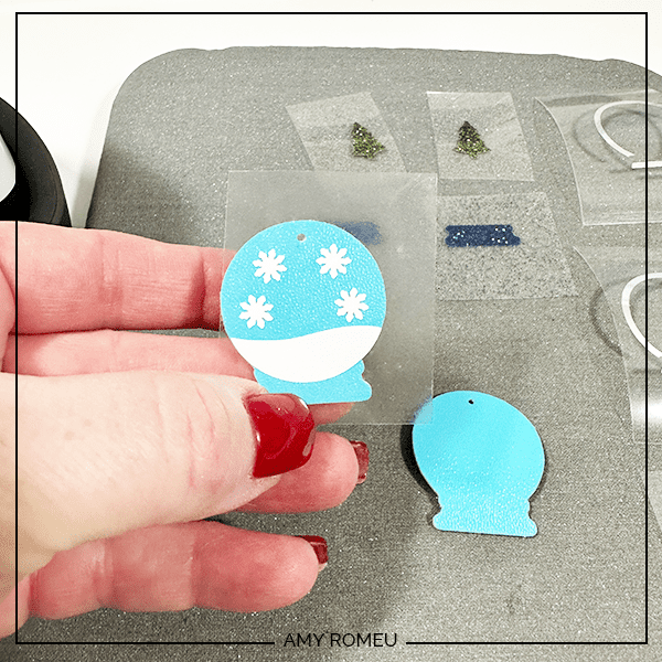 pressing heat transfer vinyl to to make faux leather snow globe earrings with Cricut