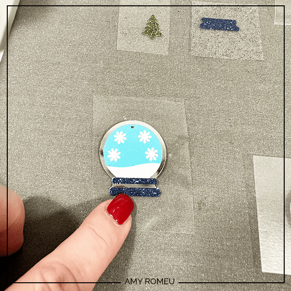 pressing heat transfer vinyl to to make faux leather snow globe earrings with Cricut