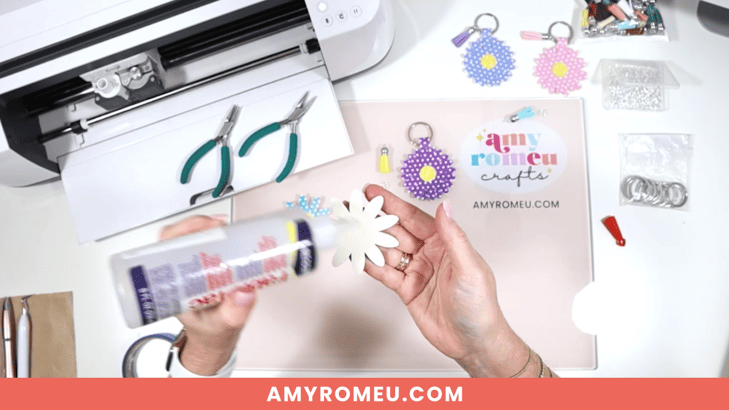 gluing faux leather daisy petals onto faux leather keychain