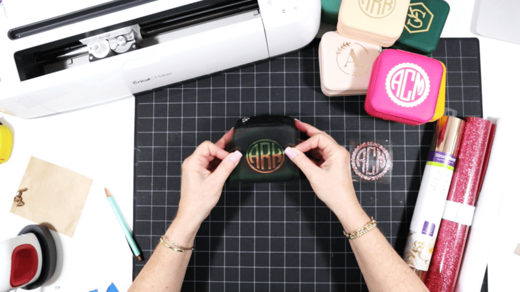 cutting and pressing heat transfer vinyl onto a travel sized jewelry box