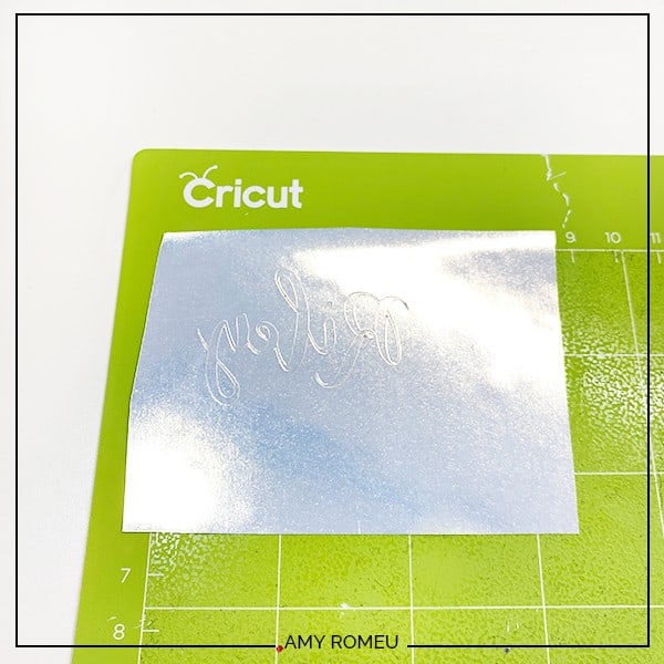 cut foil iron on placed on a green Cricut cutting mat