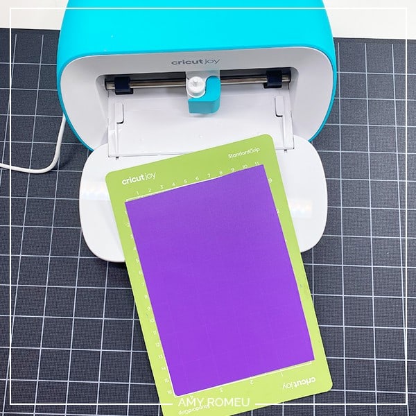 placing plastic sheet on cricut joy cutting mat for ear savers tutorial