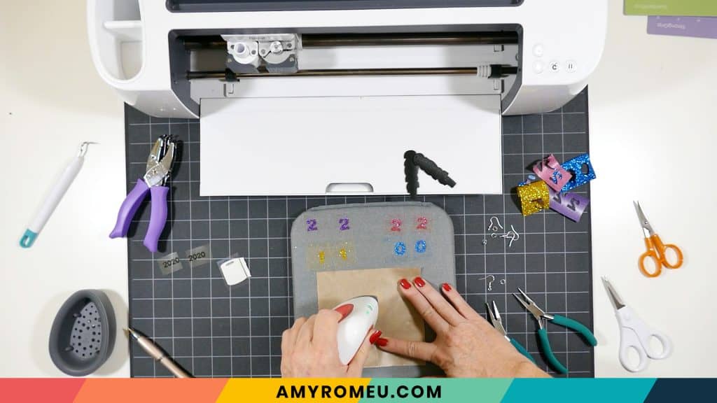 pressing HTV layers on toilet paper earrings