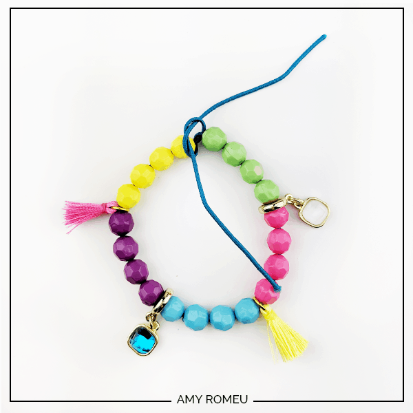 stack bracelet with beads, charms, and tassels on elastic bead cord