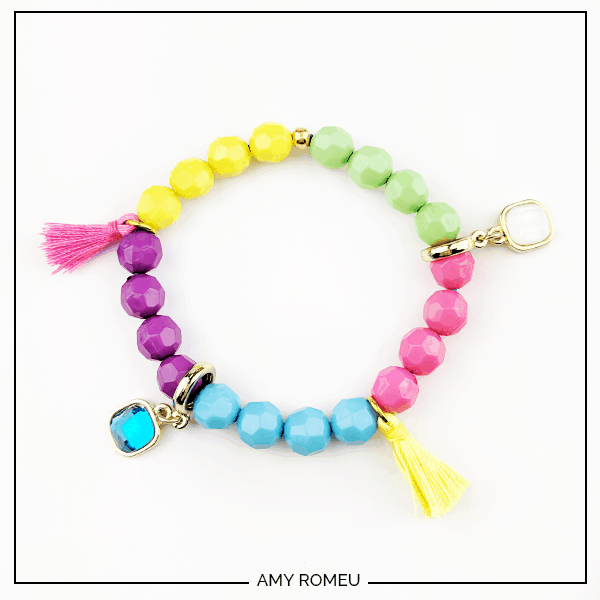 DIY stack bracelet made with beads, tassels and charms