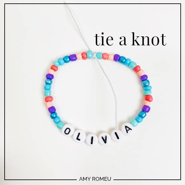 stretchy bracelet with letter beads tied in a knot