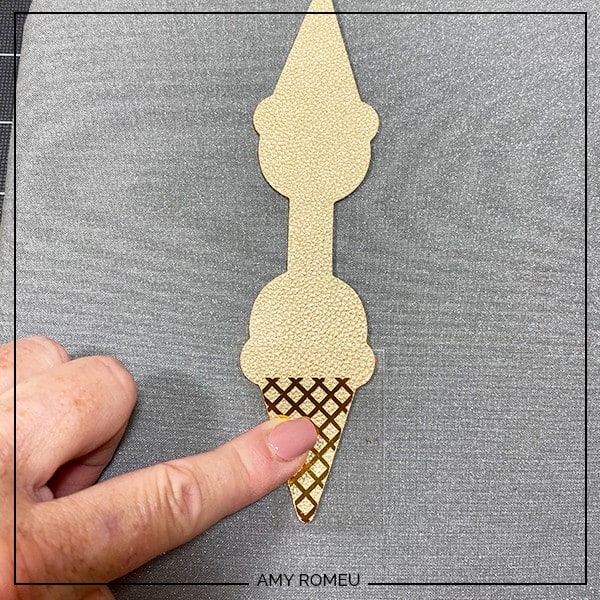 pressing foil iron on to a faux leather ice cream cone keychain