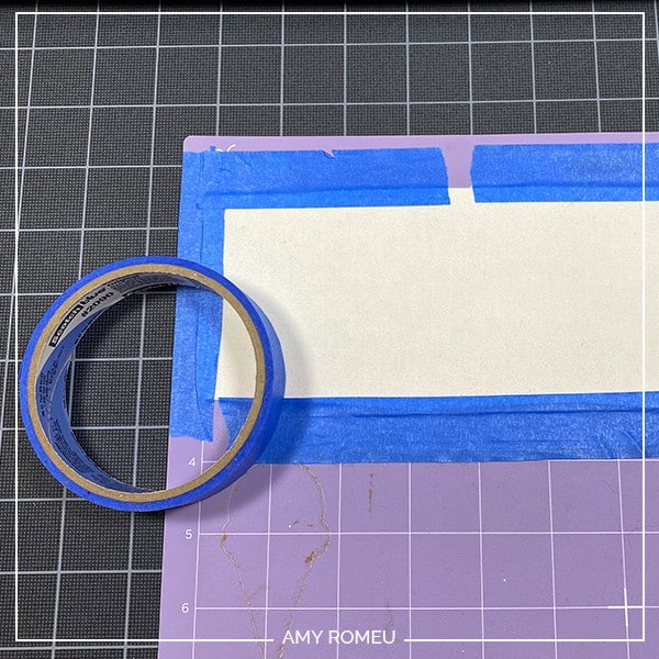 taping faux leather down to purple Cricut cutting mat