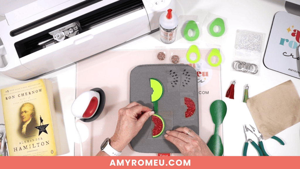 heat pressing vinyl onto faux leather while making DIY Watermelon and Avocado Faux Leather Keychains